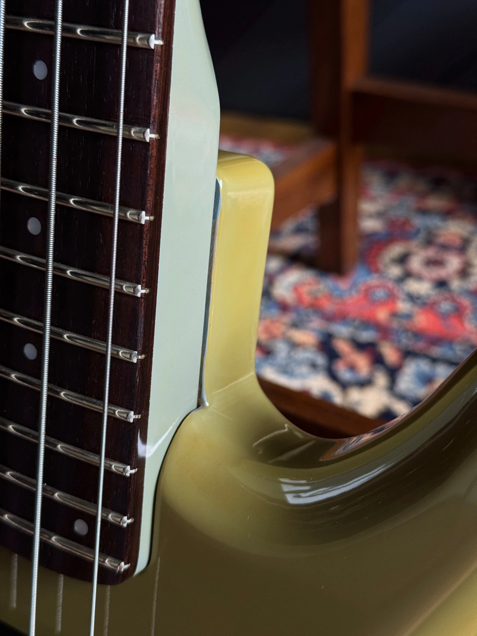 Close view of the bass body and neck joint from the back