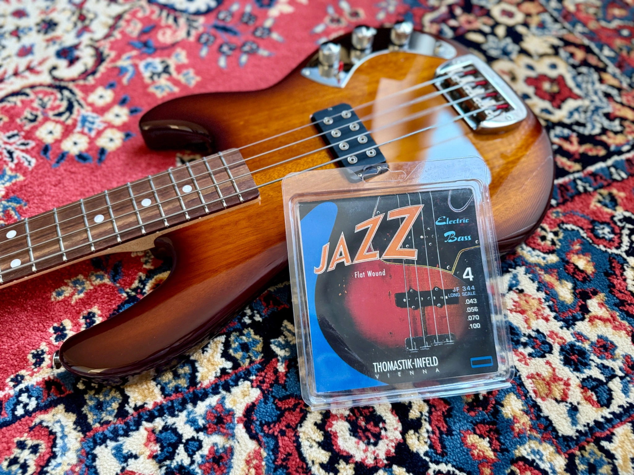 The bass with the accompanying Thomastik-Infeld Jazz Flat string packaging.