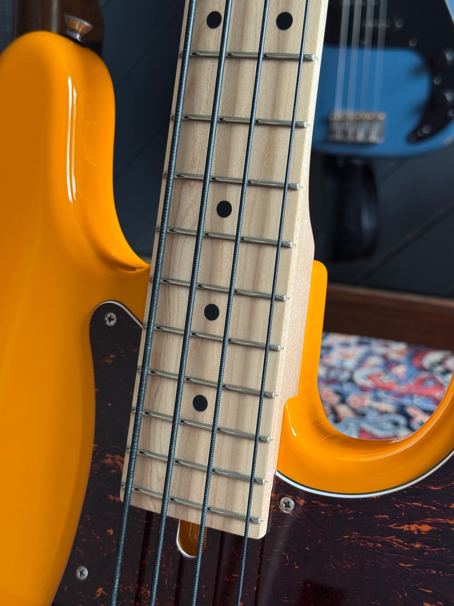 fingerboard meeting the Capri Orange body