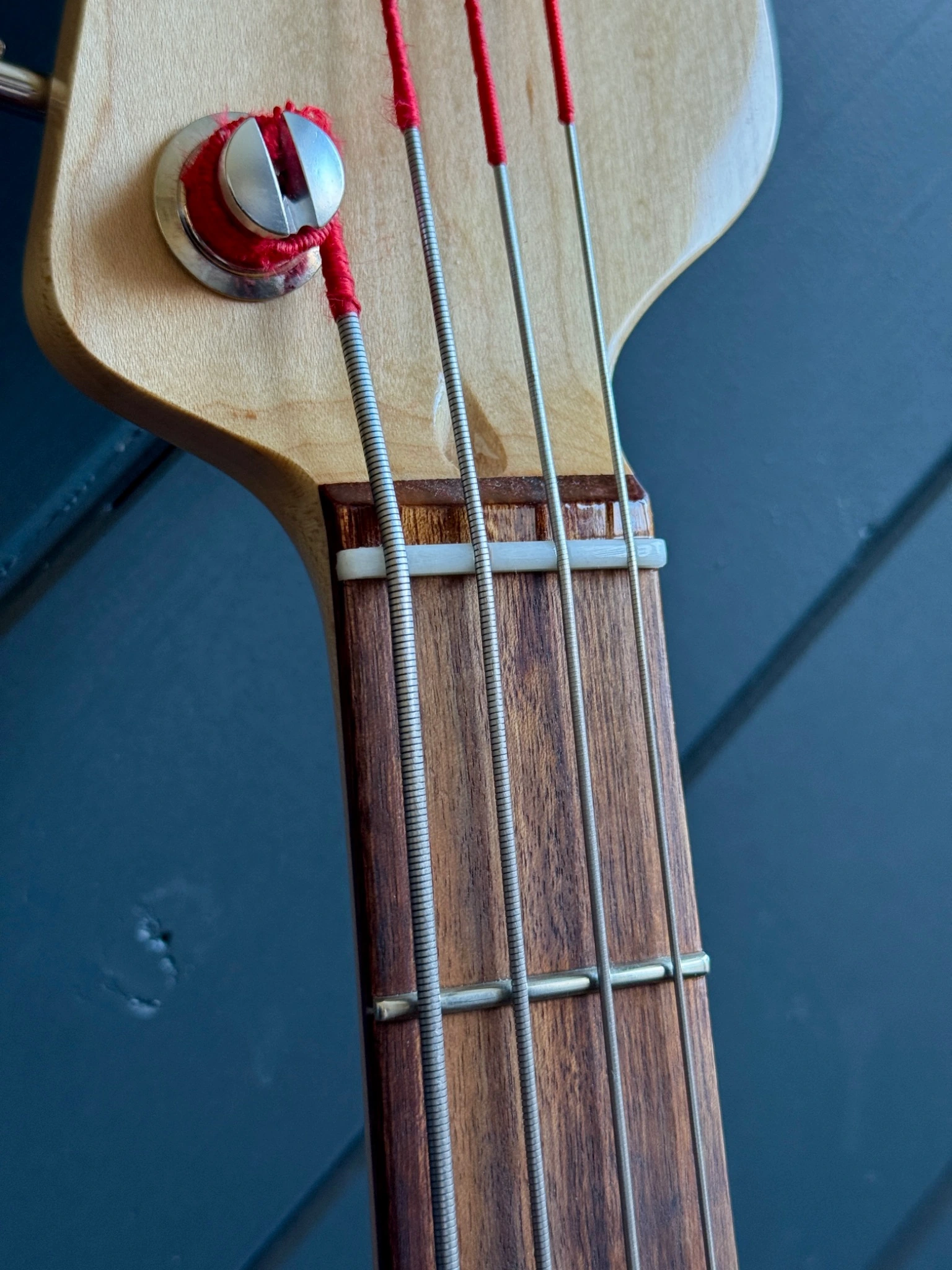 Close view of the pickup, strings and fingerboard end.