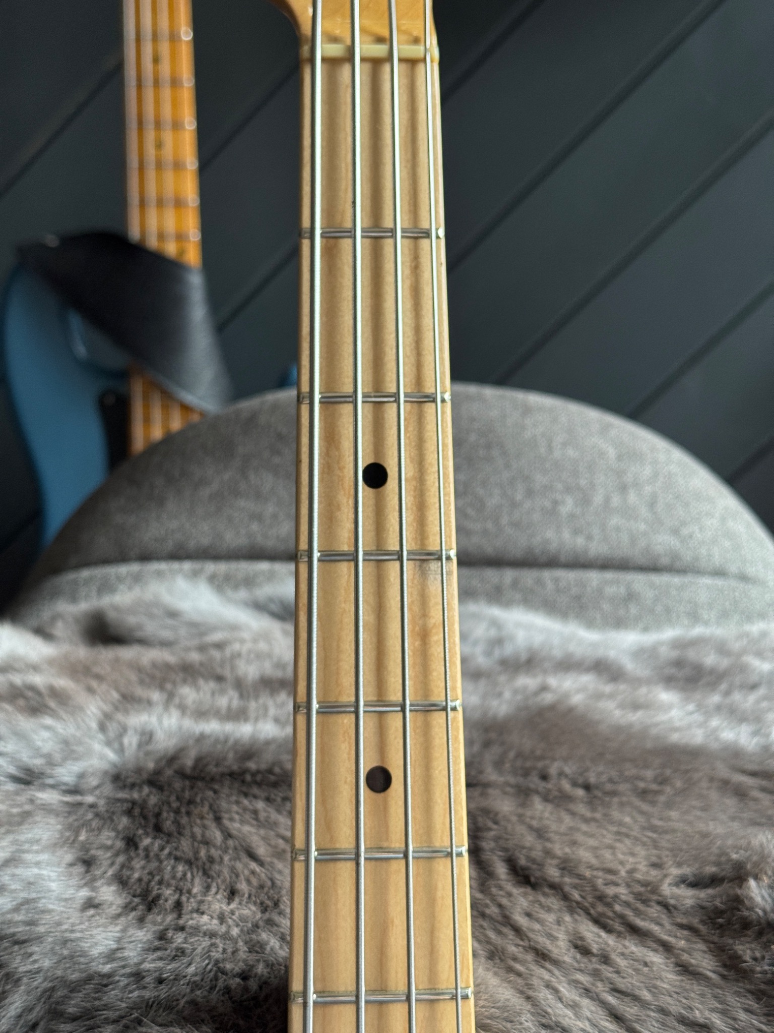 A longer view of the maple fretboard and dot markers.