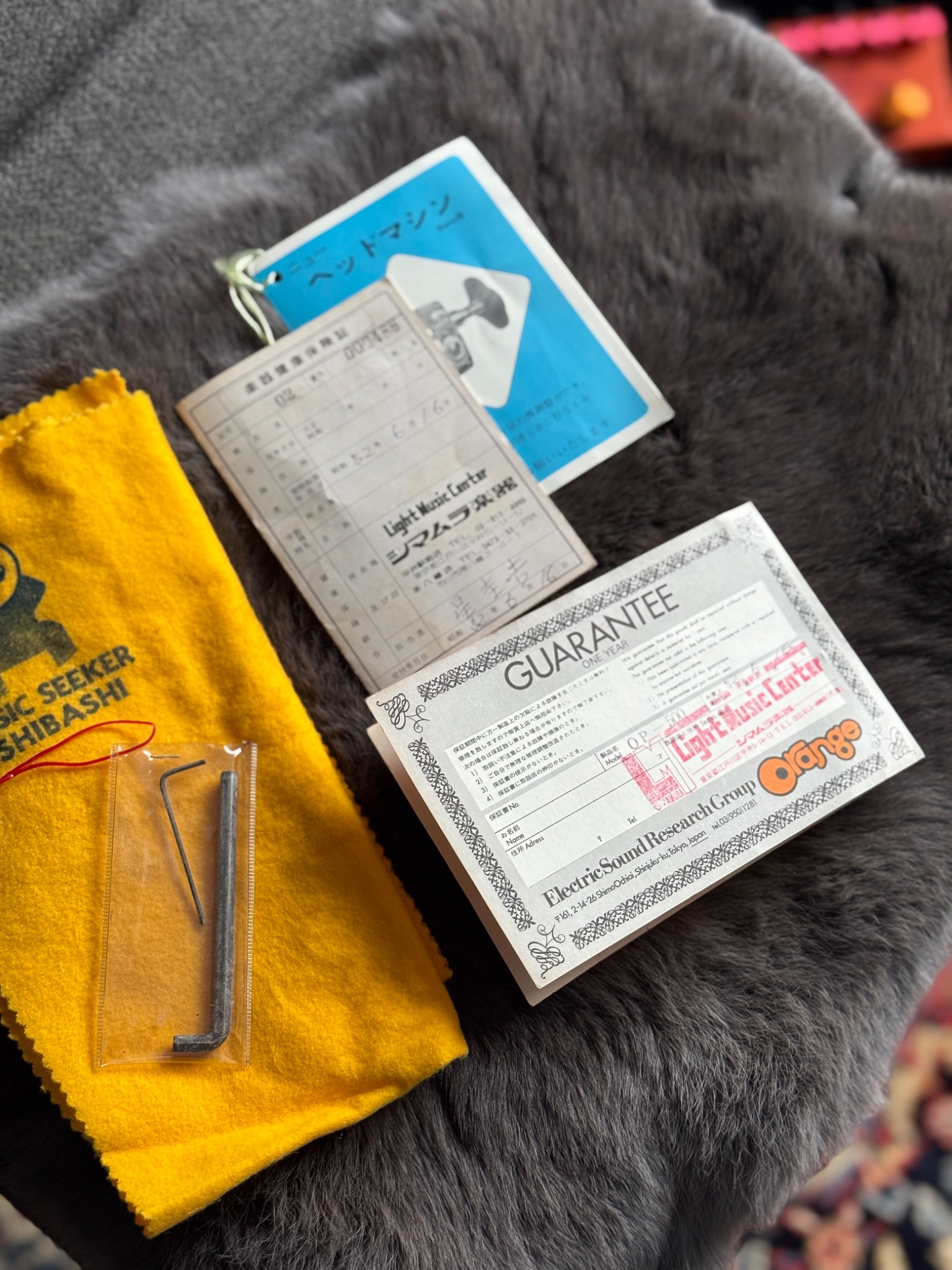 Original booklet, guarantee card and period adjustment tools shown with the Orange OP-500.