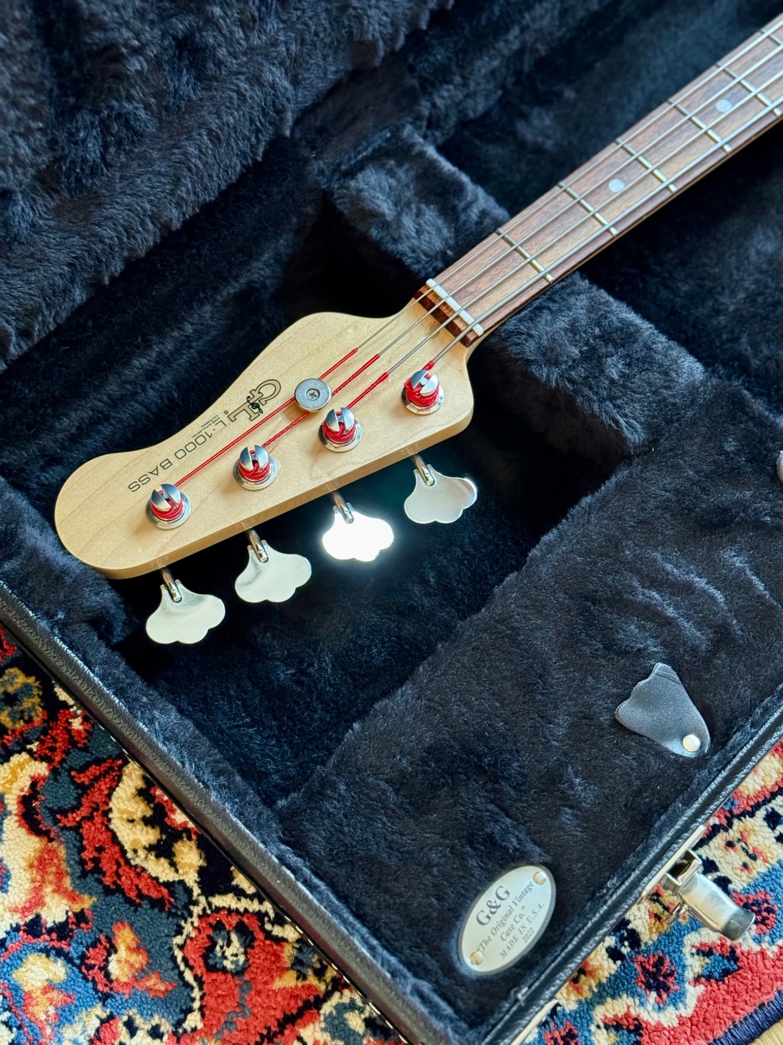 Headstock and upper neck resting inside the open hard case.