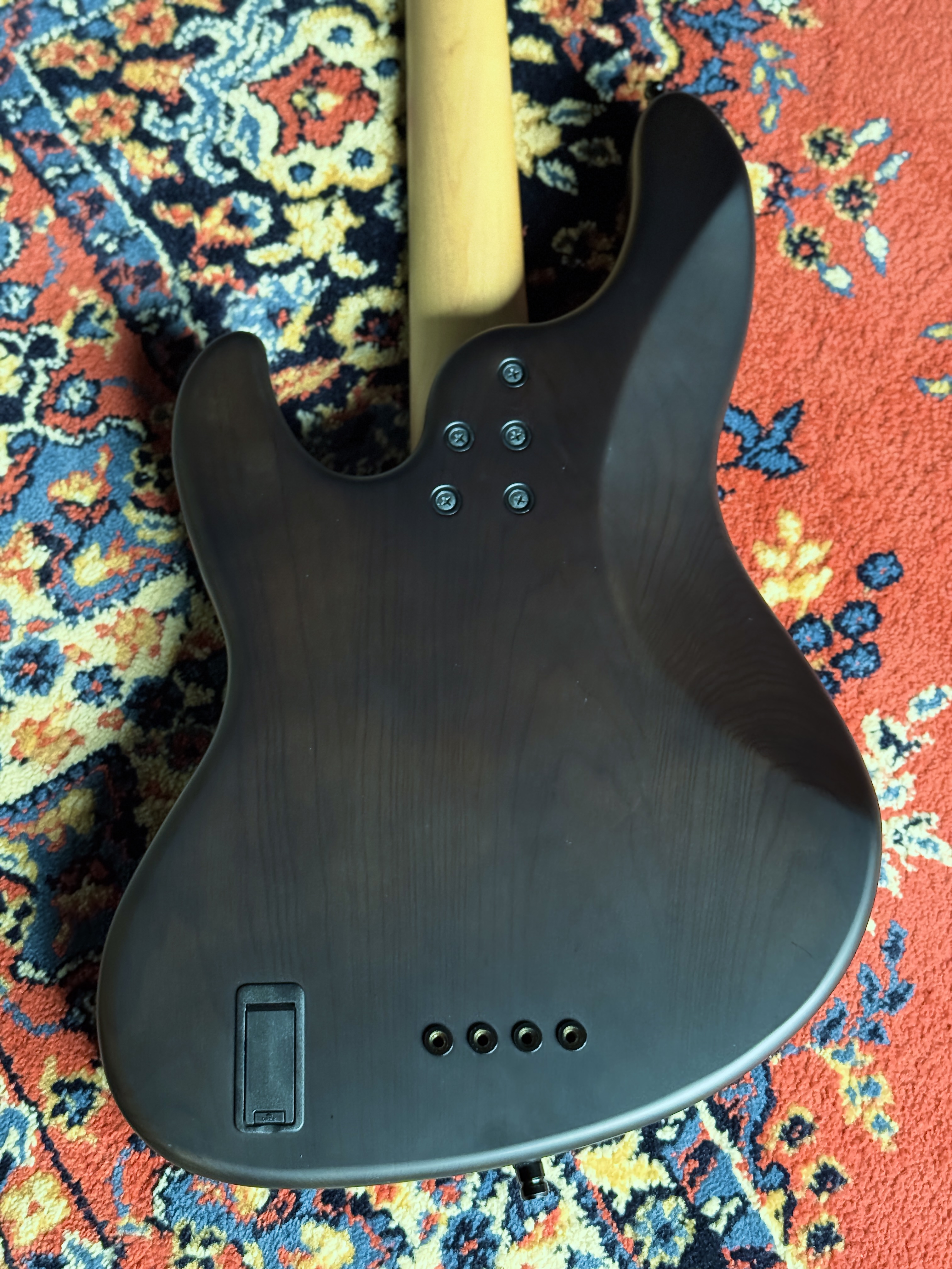 Rear view of the bass on a patterned rug